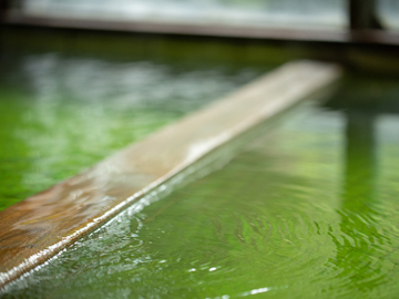 *【大浴場】体を包みこむような、柔らかさが特徴的な珍しいエメラルドグリーンの温泉です。