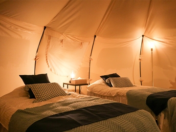 *グランピングテント／ベッド（夜）枕元には優しいライトが灯ります。